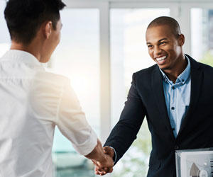 Two men shake hands at a job interview