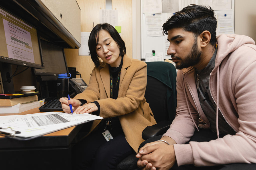 An ADVANCE Success Coach works with a student