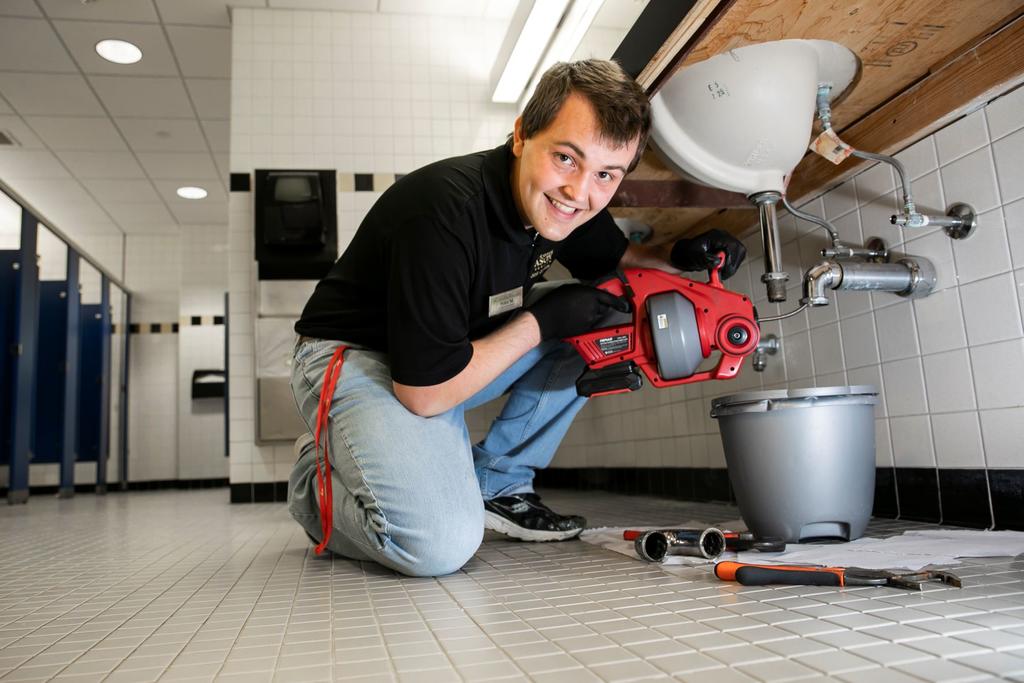Building Service Assistant repairing sink